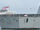 Члени екіпажу стоять на палубі HMS Dragon, який керується буксирами з військово-морської бази Портсмут на південному узбережжі Англії, 10 березня 2026 року