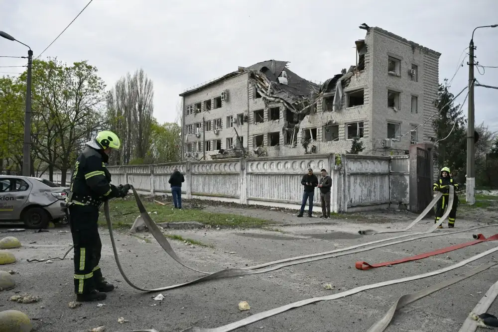 Пожежники працюють на місці події після російського удару по Києву 16 квітня