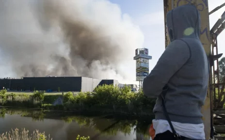 Польща: Людина дивиться на палаючий торговий центр «Marywilska 44» у Варшаві