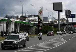 автозаправка у Росії та вивіска цін на паливо