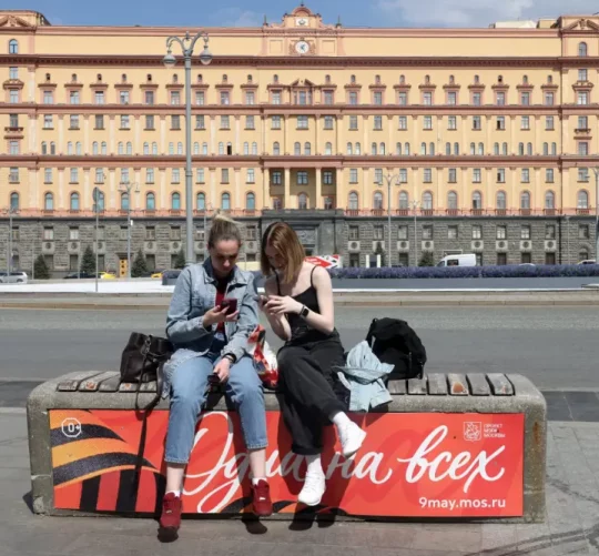 7 травня 2026 року дві жінки сидять на лавці перед будівлею Федеральної служби безпеки Росії в Москві
