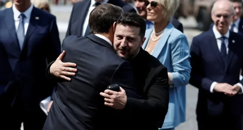 Президент Франції Еммануель Макрон обіймає президента України Володимира Зеленського після щорічного військового параду з нагоди Дня взяття Бастилії, що відбувся у вівторок у Парижі